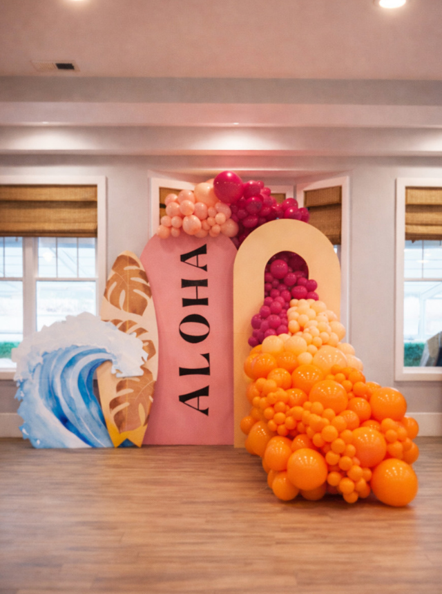 Decorative balloon setup with 'ALOHA' sign