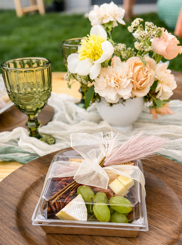 Plated appetizer with cheese, grapes, and charcuterie