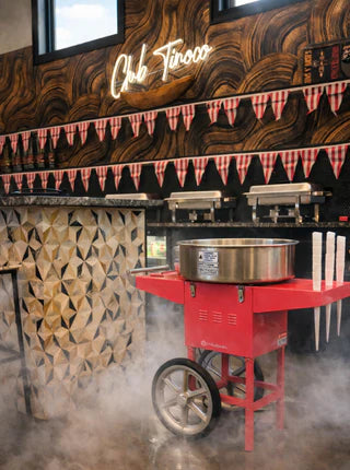 Red popcorn machine in a restaurant setting with 'Chic Taco' sign above.