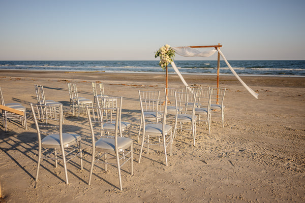 Beach ceremony setup with arch