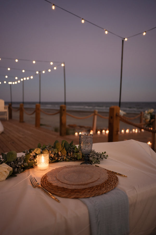 Ocean view candlelit dinner table