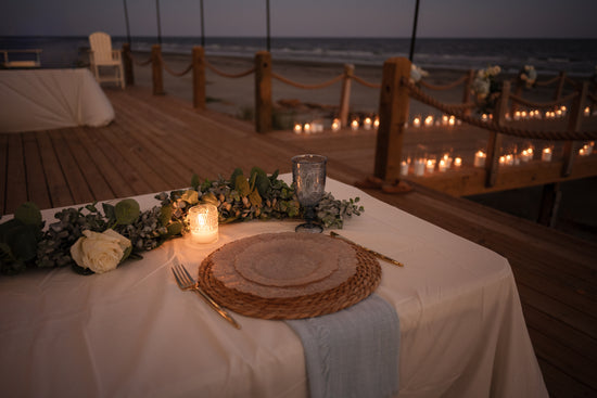 Candlelit seaside dining arrangement