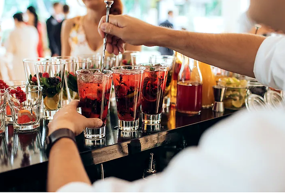 Bar Setting Person Garnishing Red Drinks